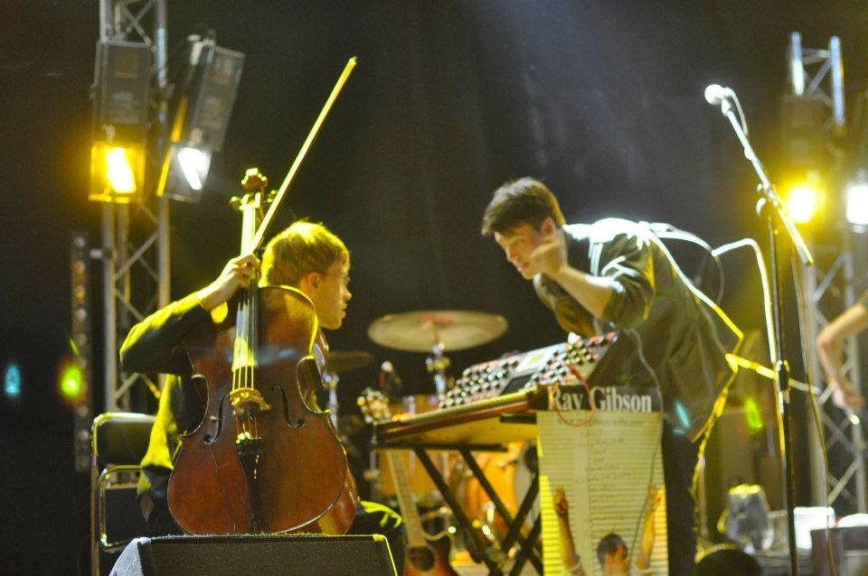 Ray Gibson on stage with cello and drums