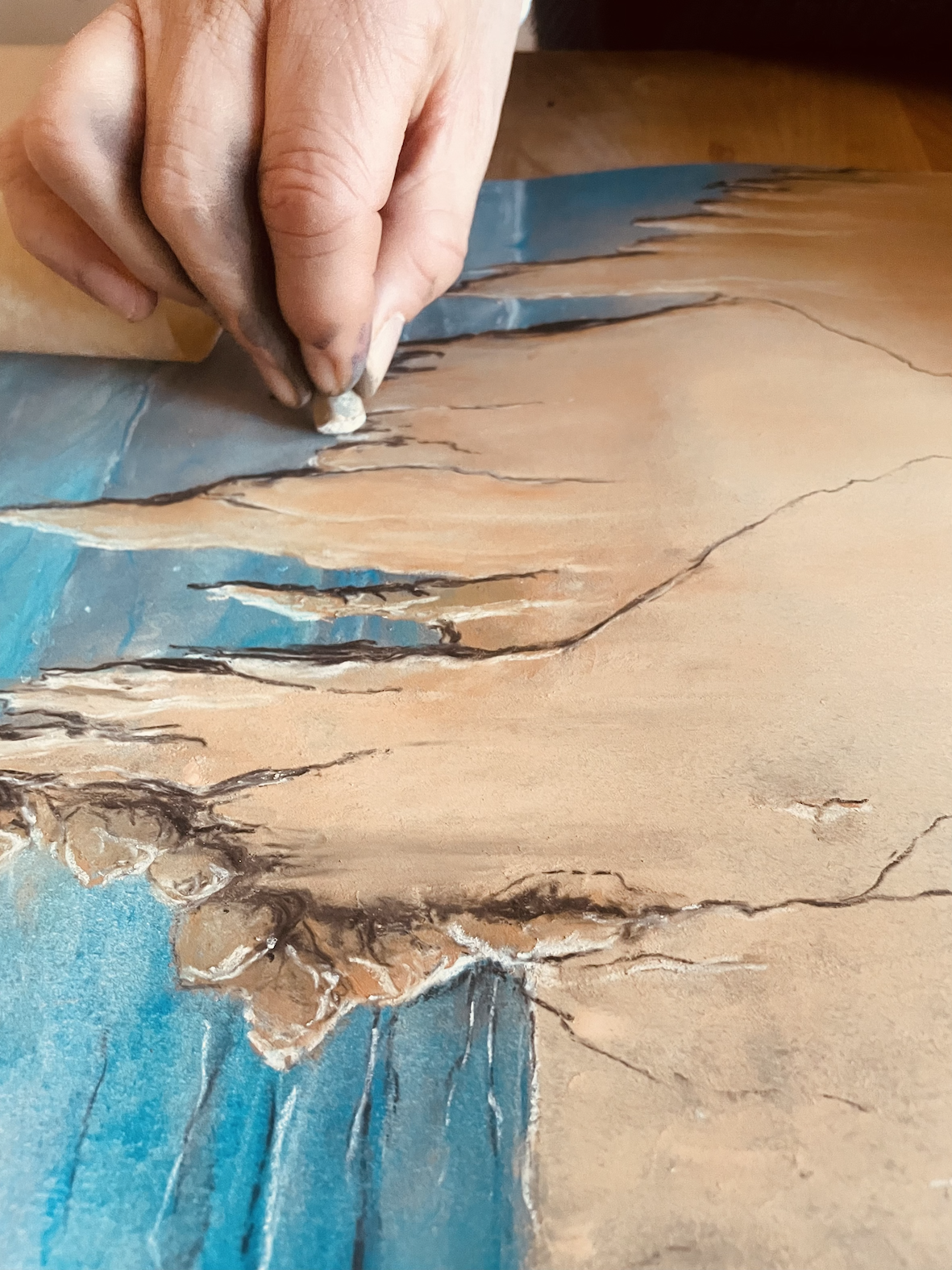 Ray Gibson working a pastel into the surface with his fingers
