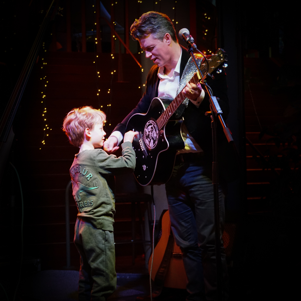 Ray Gibson playing live, his son beside him